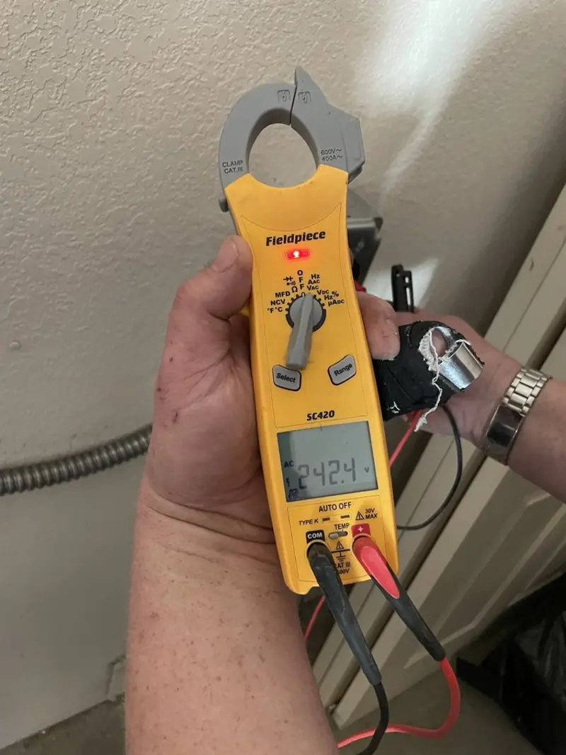 Voltage testing with clamp meter during Recessed Lighting Installation in Grand Junction